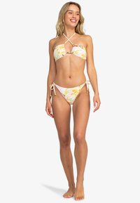 Bikini set met een bloemenpatroon in pastelkleuren. De bovenkant heeft een kruislings ontwerp en verwijderbare bandjes, terwijl de onderkant strikaccenten heeft aan de zijkanten.
