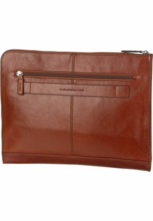 Brown leather zippered pouch with a front pocket, smooth texture, and embossed lettering reading "handcrafted since 1928."