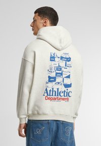 Gray hoodie featuring blue graphic of stacked shoes and boxes on the back. Cotton material; ribbed cuffs and hem; casual fit.