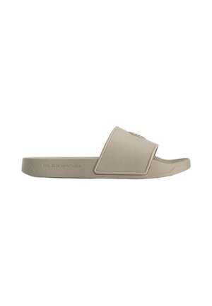 Slide sandals in light beige rubber, featuring a wide strap and textured footbed. Hardware accents are minimal with a logo detail on the strap.