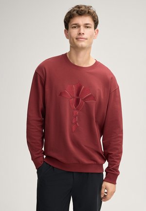 Bordeauxfarbener Sweatshirt aus weicher Stoff, mit einem strukturierten Blumendesign in der Mitte sowie gerippten Bündchen und Saum.