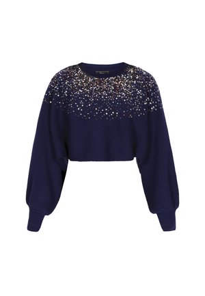 Merinovärinen lyhyt neulepusero, jossa on pitkät hihat, ribatttu pinta ja koristeltu hopea- ja kultapainanteilla ylhäällä.