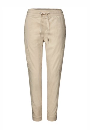 Beige cotton blend jogger pants with a drawstring waist, tapered legs, side pockets, and soft texture. Features a casual, relaxed design.