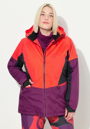 Bunt gefärbte, mit Reißverschluss versehene Jacke mit einer Kombination aus leuchtend roten, schwarzen und lila Einsätzen. Verfügt über elastische Bündchen und Seitentaschen.