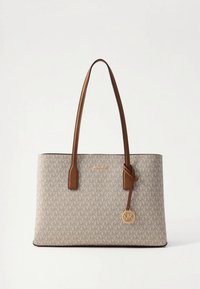 Beige tote bag with a textured monogram pattern, brown leather handles, gold hardware, and a detachable logo charm.