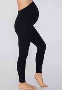 Leggings de maternité noirs avec un tissu lisse et extensible, une taille haute et un design ajusté, adaptés pour un port confortable.