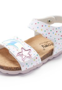 Sandale blanche avec des pois multicolores, deux sangles réglables, une semelle en liège et un accent décoratif en forme d'étoile sur le dessus.