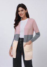 Knitted cardigan in pink, gray, and cream colors. Features two front pockets and a slightly textured fabric with open front design.