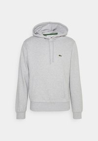 Felpa lacoste leggera grigia con tasca frontale, cappuccio con cordino, polsini a costine e piccolo logo coccodrillo verde sul lato sinistro del petto.