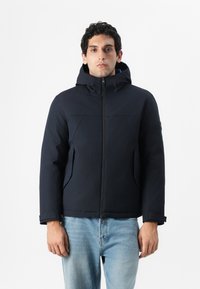 Navy hooded jacket made from soft, water-resistant fabric. Features a zip front, two side pockets, and a relaxed fit for comfort.