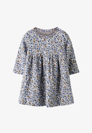 Vestido floral de manga larga, confeccionado en tela ligera. Presenta un fondo blanco con pequeñas flores azules y marrones, y cintura fruncida.