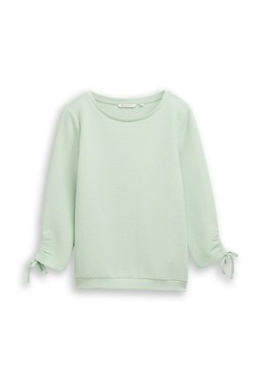 Mintgroene sweatshirt met textuur, driekwart mouwen en trekkoorddetails aan de manchetten. Ronde halslijn en een losse pasvorm.