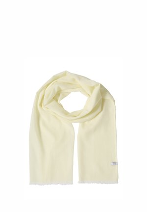 Sciarpa in tessuto morbido giallo chiaro con sottili bordi sfrangiati, disposta in un anello sciolto con le estremità che pendono dritte.