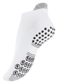 Calzino bianco alla caviglia con parte superiore a coste, tallone grigio e puntini antiscivolo neri sulla suola. Realizzato in un tessuto texturizzato per aderenza e comfort.