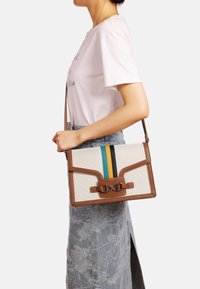 Borsa a spalla in tela con accenti in pelle marrone, caratterizzata da strisce blu, gialle e nere. Forma rettangolare con pattina pieghevole e fibbia.