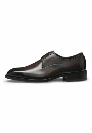 Brown leather dress shoe with a smooth finish, pointed toe, minimal lacing, and a low, stacked heel. Simple design with subtle stitching details.