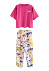Top corto a maniche corte in cotone rosa con un piccolo dettaglio a fiocco. Pantaloni bianchi con vita elastica coordinati, decorati con un motivo colorato di fiocchi.