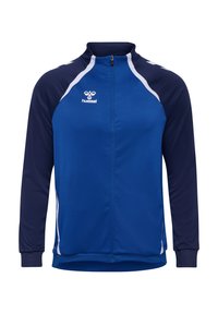 Veste de survêtement bleue et marine avec un col haut, des manches longues, une fermeture à zip et des accents blancs. Logo sur la poitrine. Texture lisse.