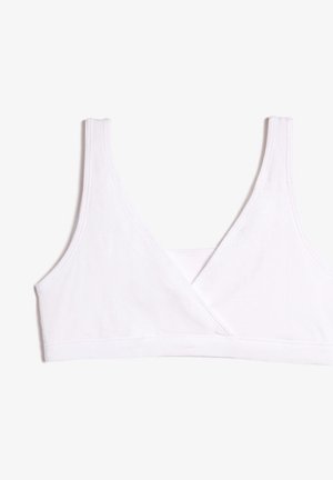 Witte, naadloze bralette gemaakt van zachte stof, met een kruislings ontwerp aan de voorkant, brede banden en een gladde textuur. Geen versieringen.