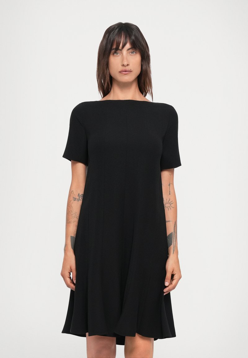 Black short-sleeve dress made from lightweight fabric, featuring a round neckline and flared skirt, with a simple, clean design and no patterns.