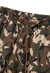 Camouflage joggers in tinten van bruin, groen en beige. Heeft een elastische tailleband met een trekkoord en een zachte stofstructuur.