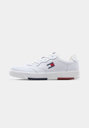 White athletic shoes with a smooth synthetic upper, lace-up design, contrasting navy and red accents on the sole, and perforated detailing.