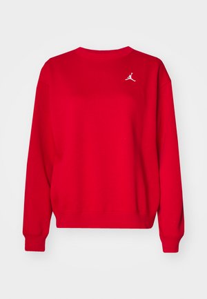 Red cotton sweatshirt featuring a crew neck, ribbed cuffs, and hem. Includes a white Jumpman logo on the left chest. Smooth texture.