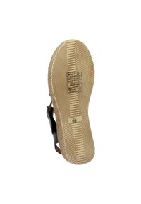 Semelle de sandale brune avec un fond en caoutchouc texturé. Marquage de marque embossé et taille (39) visibles. Détails de sangle et de couture brun clair.