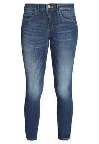 Jeans ajustados de denim con un lavado azul oscuro, que cuentan con bolsillos delanteros, un cierre de botón y una textura ligeramente deslavada.