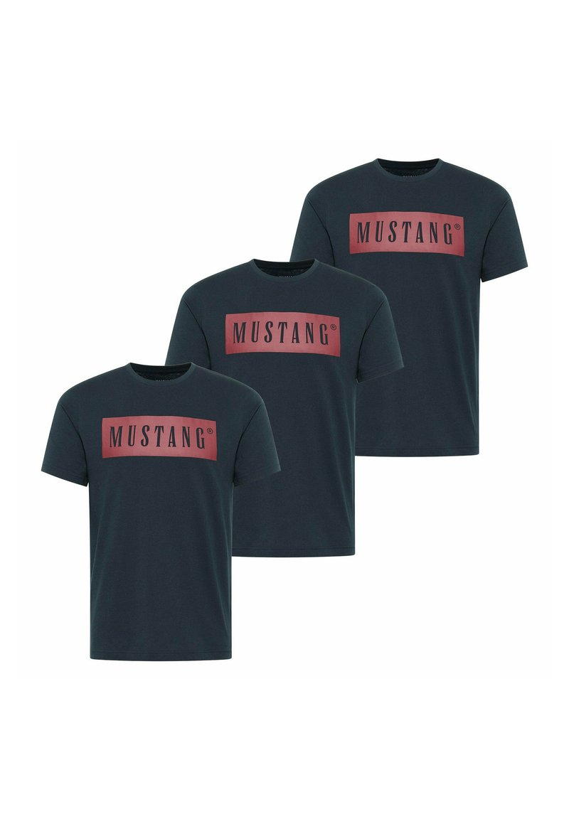 Three dark teal t-shirts made of cotton, featuring a large rectangular red logo with the text "MUSTANG" in black. Short sleeves and crew neck.