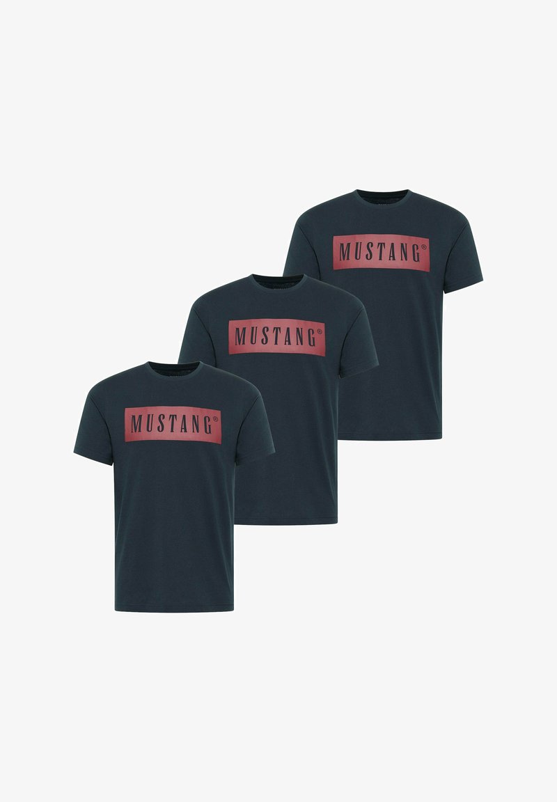 Three dark teal t-shirts made of cotton, featuring a large rectangular red logo with the text "MUSTANG" in black. Short sleeves and crew neck.