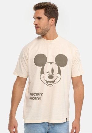Kermansan värinen puuvillapaita, jossa on suuri painettu grafiikka Mikki Hiiren kasvoista ja teksti "MICKEY MOUSE" tummanharmaana.