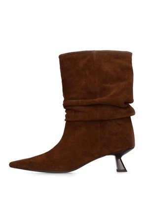 Brown suede mid-calf boot with pointed toe, slouchy shaft, and short angled black heel.