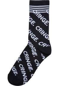 Čierne bavlnené ponožky s opakujúcim sa bielym vzorom "CRINGE". Rífovaný povrch, s tromi horizontálnymi bielymi pruhmi na vrchu.