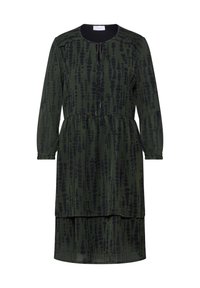 Zelené šaty s texturovaným vzorem tmavých teček, dlouhými rukávy, kulatým výstřihem a vrstveným designem. Lehce pádový materiál s volným střihem.