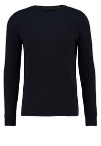 Pull à col rond bleu marine en tissu doux, avec manches longues, ourlet côtelé et logo subtil sur la poitrine.