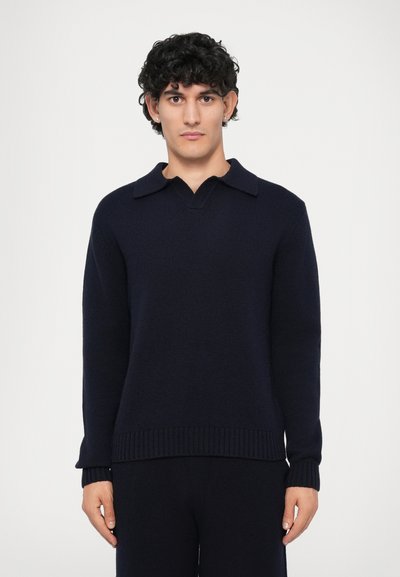 Navy blue knitted pullover with a V-neck and flat collar. Ribbed cuffs and hem. Soft texture, medium weight, and long sleeves.