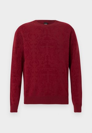 Červený svetr s texturovaným vzorem, kulatým výstřihem a žebrovanými manžetami a lemem. Vyrobený z měkkého materiálu, který poskytuje teplý a pohodlný pocit.