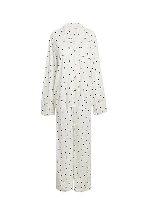 Wit pyjamashirt met lange mouwen en knopen, met zwarte stippen en bijpassende losse broek.