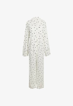 Wit pyjamashirt met lange mouwen en knopen, met zwarte stippen en bijpassende losse broek.