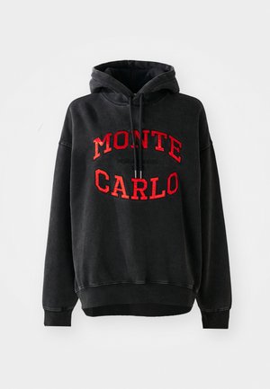 Black hooded sweatshirt with red "MONTE CARLO" lettering and drawstrings, featuring a relaxed fit and ribbed cuffs and hem.