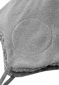 Close-up of gray fleece fabric with a circular reinforced patch and attached knitted gray cords.