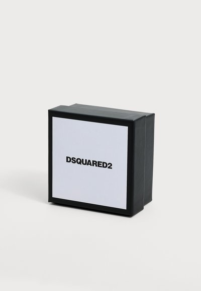 Boîte carrée DSQUARED2 noir et blanc avec bordure noire sur fond clair uni.