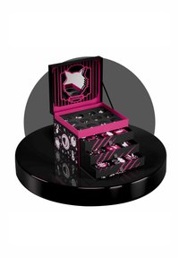 Black and pink open advent calendar with three numbered drawers and twelve small decorative items inside, placed on a round black platform.