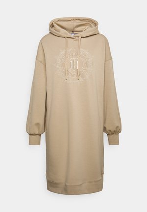 Beiges Kapuzen-Sweatshirtkleid aus weichem Material mit vorderem Logodesign und gepufften Ärmeln. Verfügt über eine Kordelzugkapuze und gerippte Bündchen.