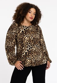 Bluse mit Leopardenmuster, die einen Rundhalsausschnitt, lange Puffärmel und eine lässige Passform bietet. Hergestellt aus weichem, strukturiertem Stoff mit schwarzen Akzenten.