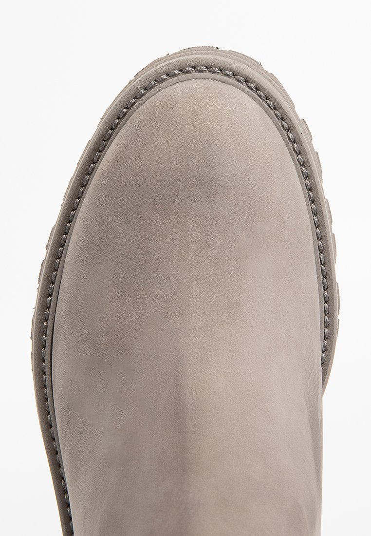 Grauer Wildlederstiefel mit runder Zehenpartie, der eine strukturierte Oberfläche und detaillierte Nähte entlang der oberen Kante und der Sohle aufweist.