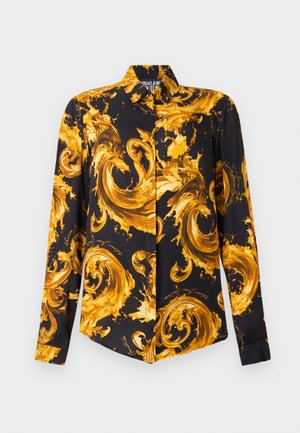 Camicia nera a maniche lunghe con bottoni, decorata con audaci motivi barocchi a spirale di colore giallo oro su tutta la superficie.