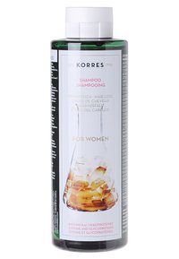 Grüne Kunststoff-Shampoo-Flasche mit einem weißen Deckel. Das Etikett zeigt einen Laborfluss mit gelb-orangefarbenen Steinen, der Text ist in mehreren Sprachen verfasst.