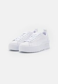 Vita plattformsneakers med en slät syntetisk ovandel, rund tå, snörning framtill, vadderad krage och en texturerad gummisula med logotyper.